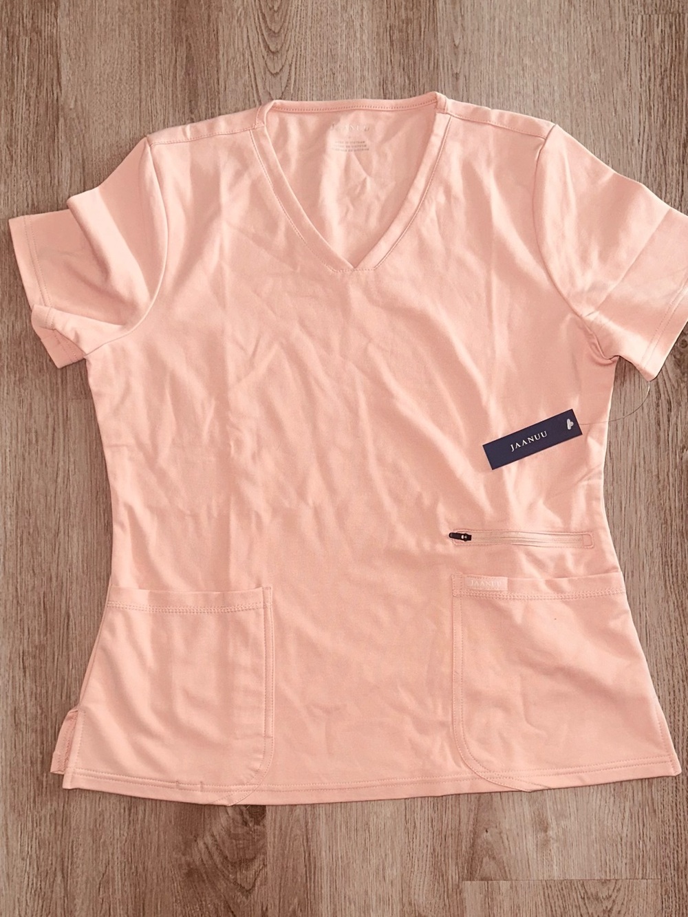 Jaanuu Short-Sleeve V-Neck Scrub Top in Blushing Pink.